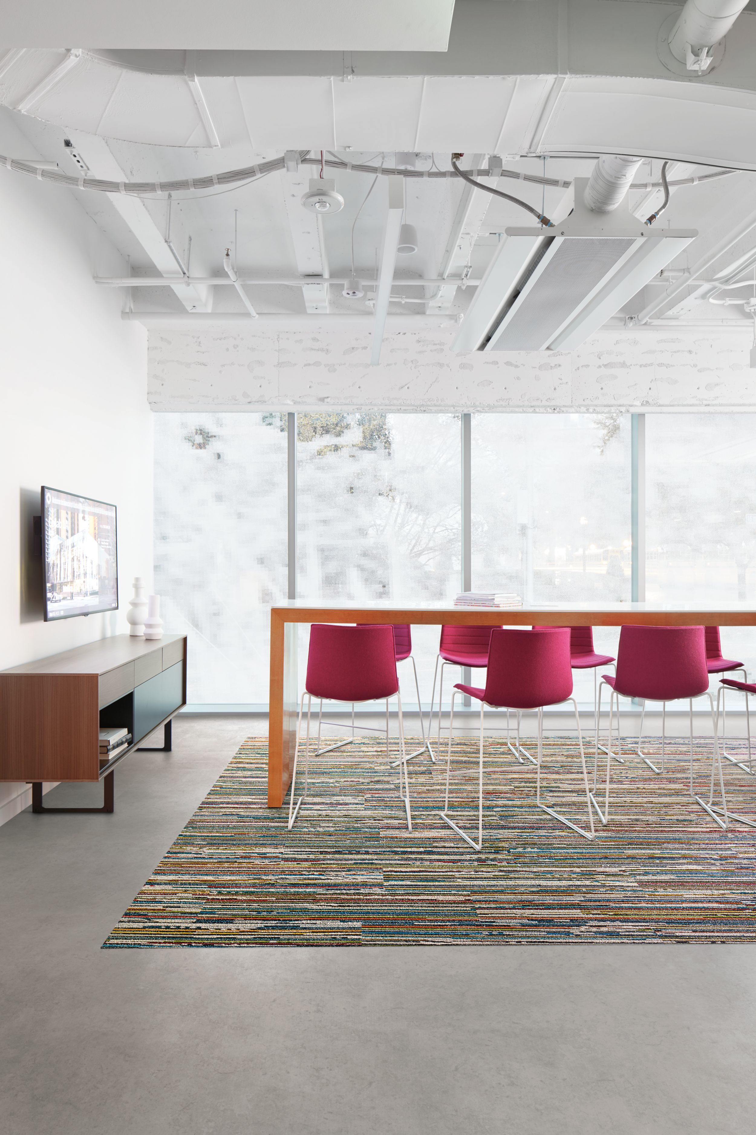 Interface Video Spectrum carpet tile and Textured Stones LVT in meeting room with high top table and pink chairs  image number 4